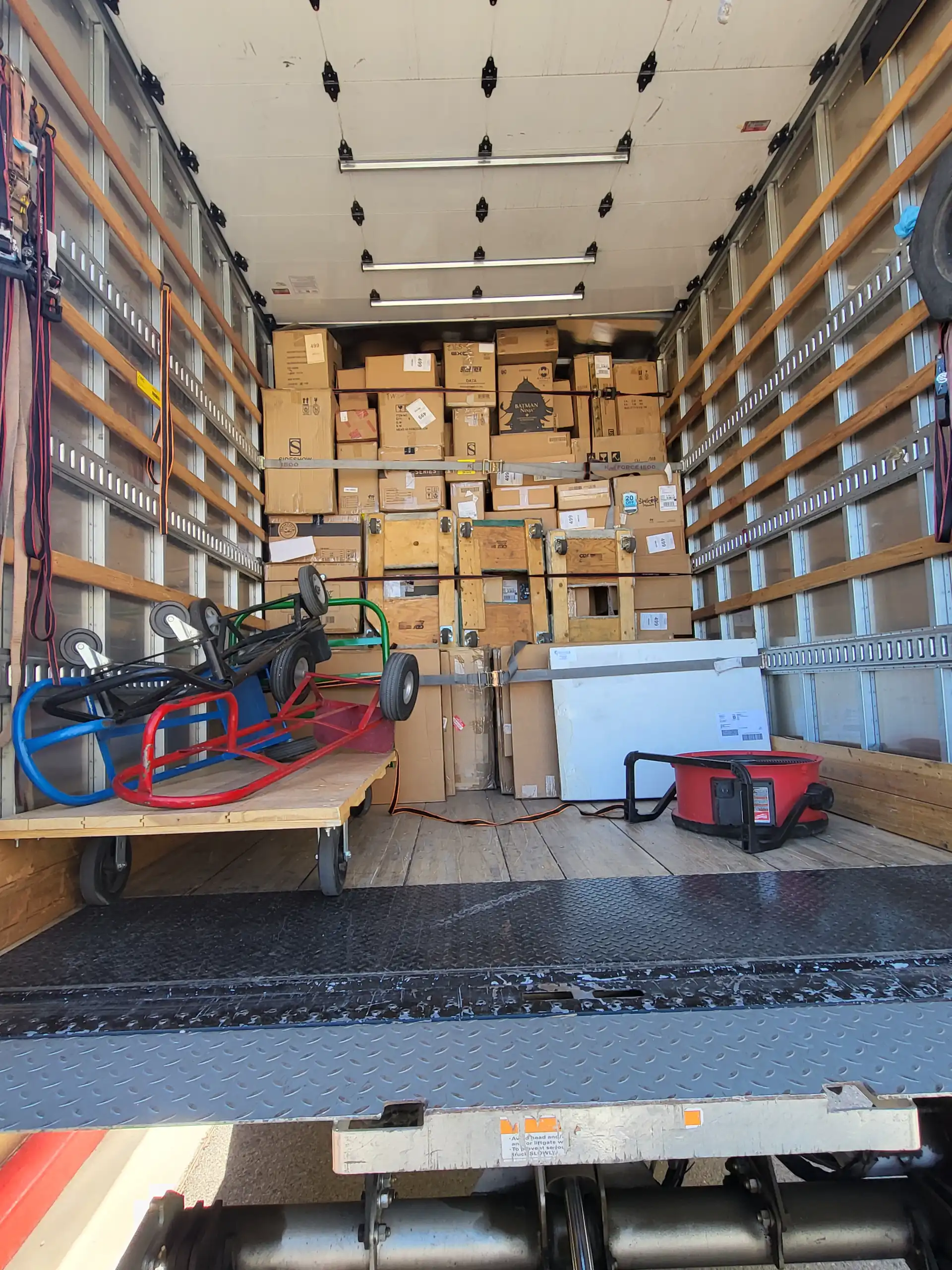 Staff member loading boxes into a delivery truck